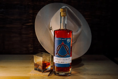 Bottle of Oakley Signature Blend Kentucky Straight Bourbon Whiskey with glass